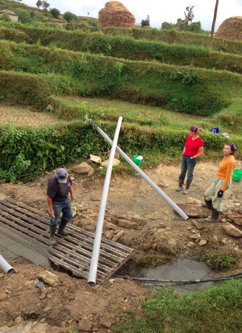 Setting the new grate over the culvert